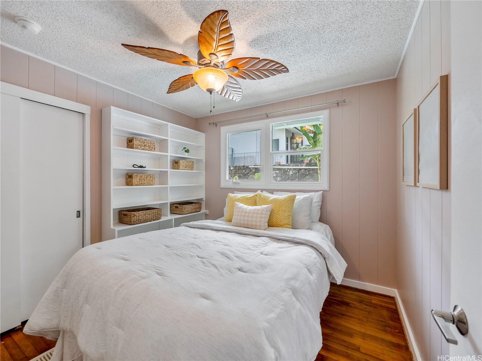 Bedroom with built-in shelving and garden views