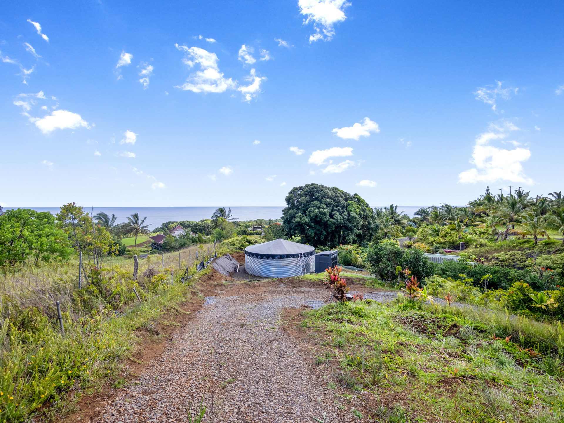 Ocean view down the driveway to the water catchment tank