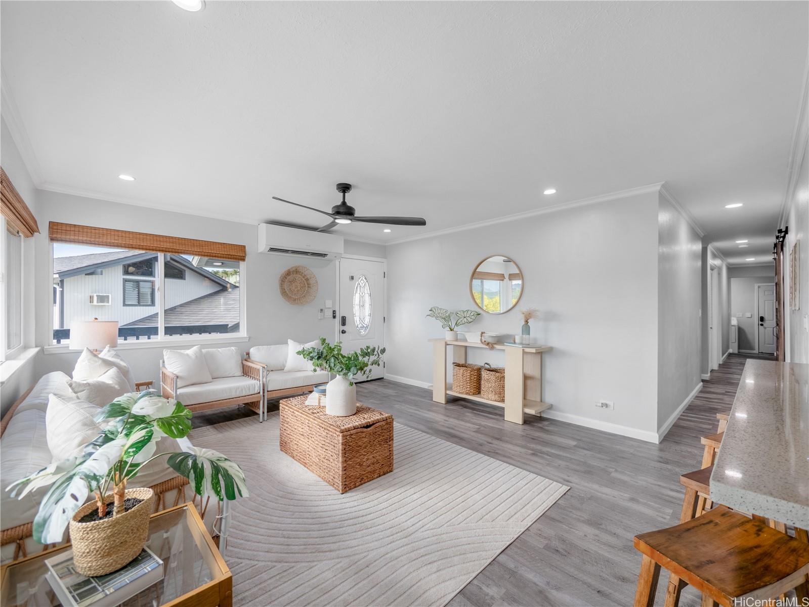 Entry living area with open hallway and bar seating