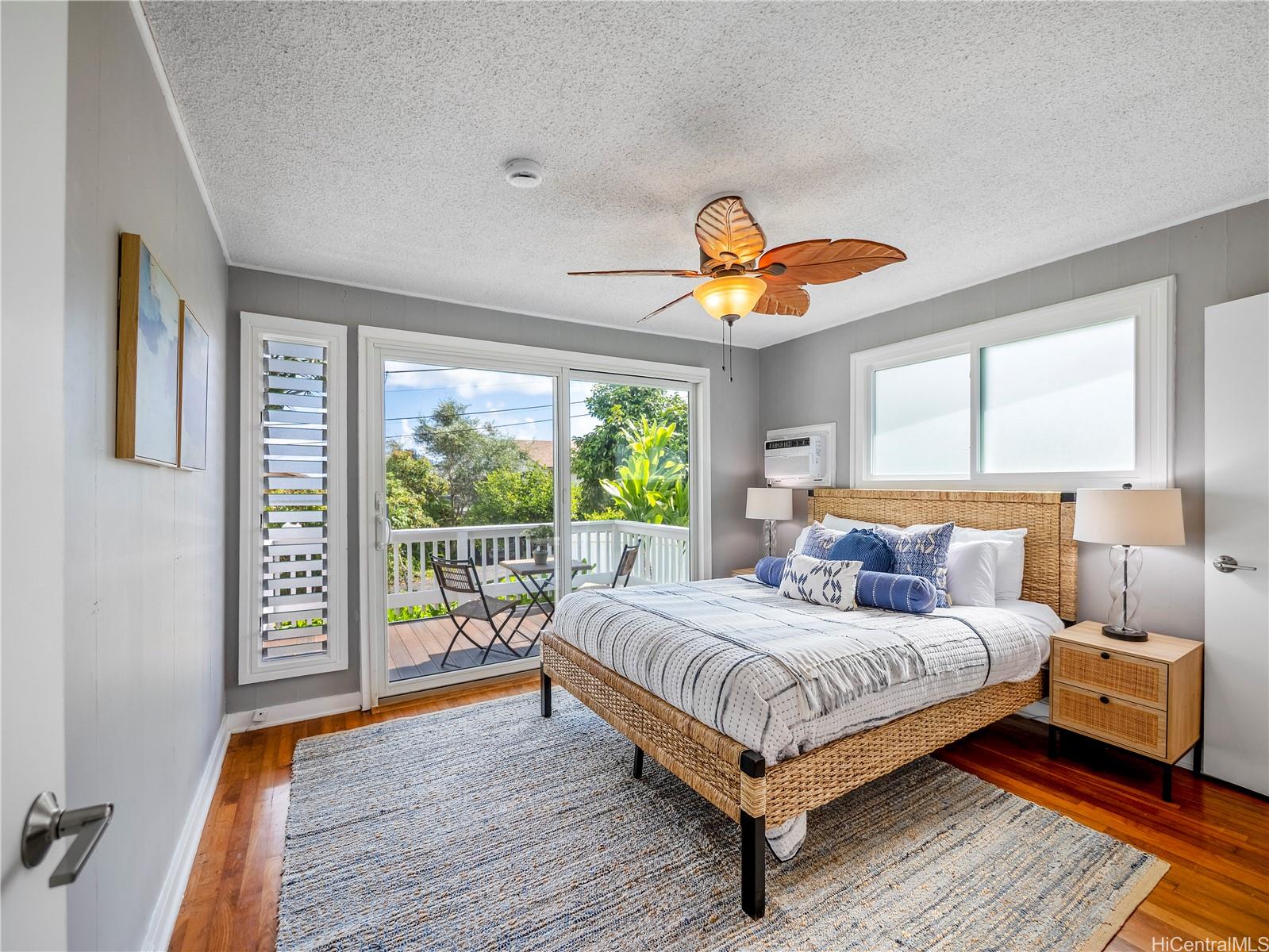 Primary bedroom with private deck access and split A/C
